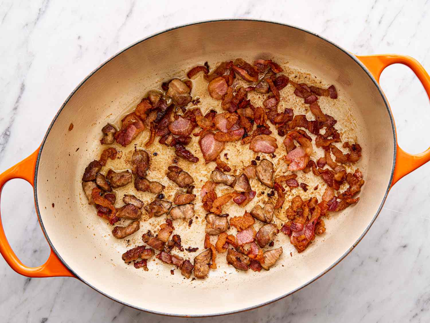 Overhead view of bacon rendered in a dutch oven