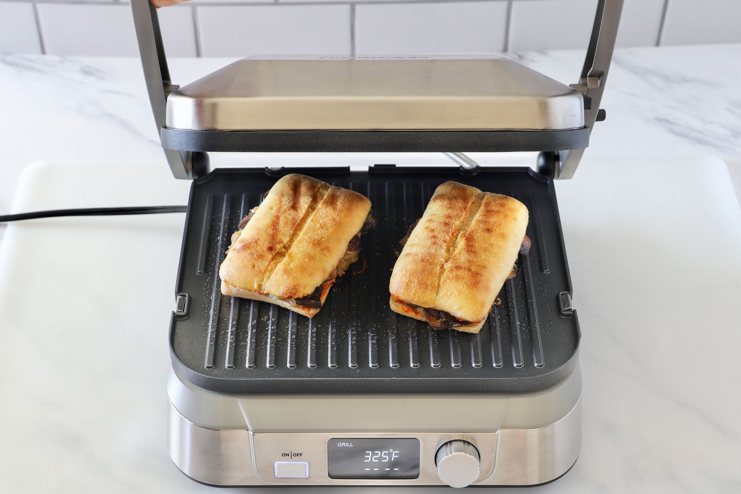 two panini on a panini press with its lid open