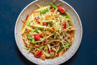 Overhead of a serving bowl of som tam Thai.