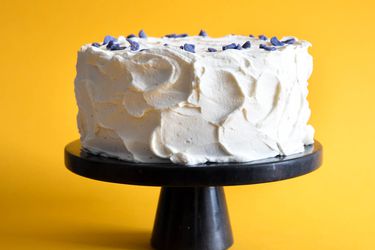 A chiffon cake on a black cake stand.