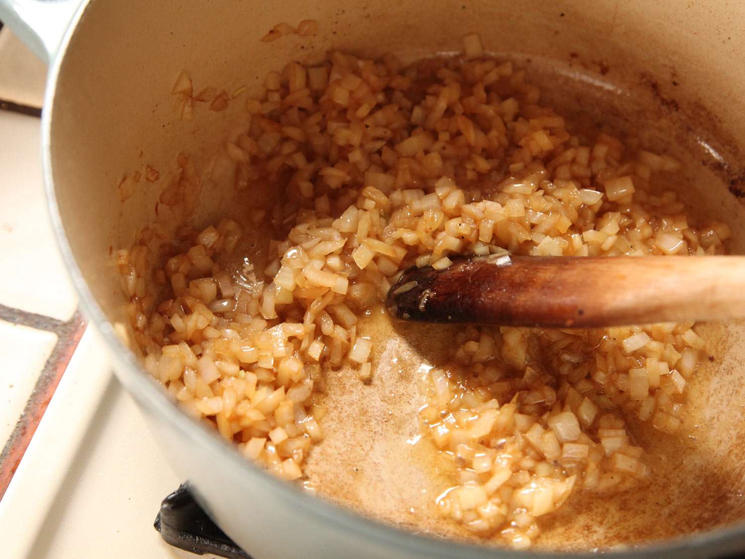 Sautéing onion in a Dutch oven for cassoulet.