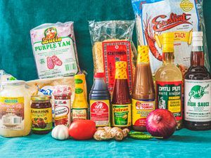 The essential elements of a Filipino pantry arranged in front of a blue backdrop