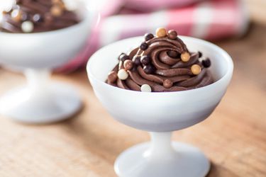 A dessert bowl filled with homemade eggless chocolate mousse.