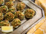 A tray of easy, ultimate Clams Casino with a lemon wedge.