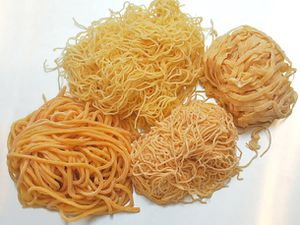 Four piles of different styles of egg noodles