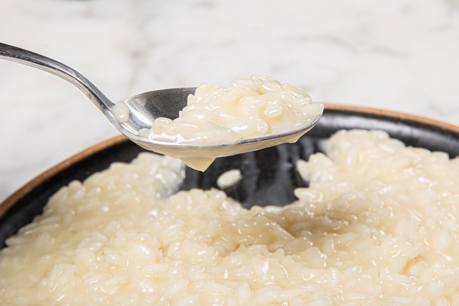 Side view of spoon full of risotto