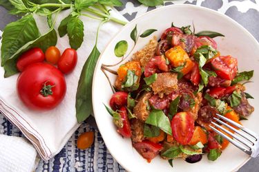 Panzanella salad with tomatoes and basil in a bowl.