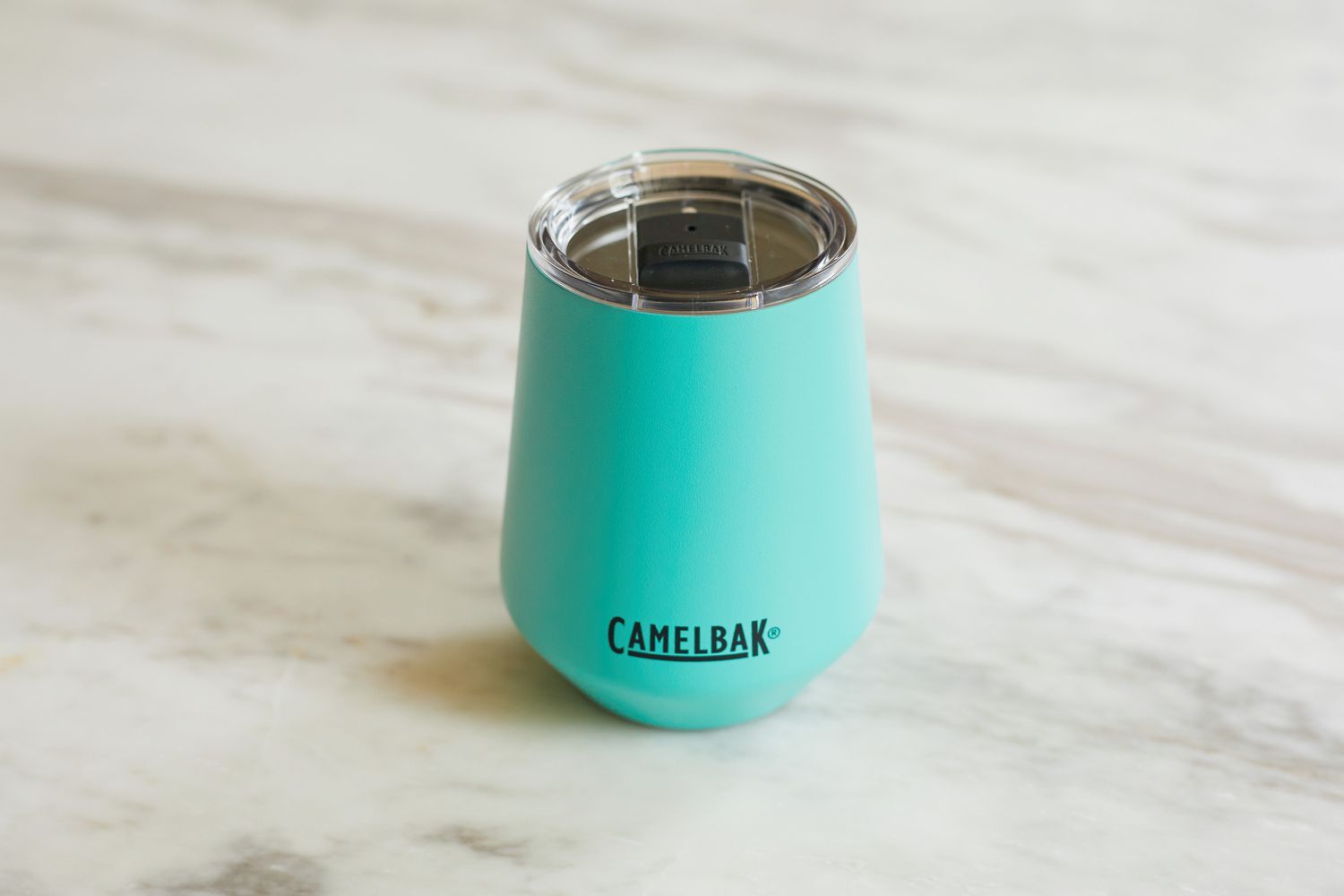 a blue wine tumbler on a marble surface