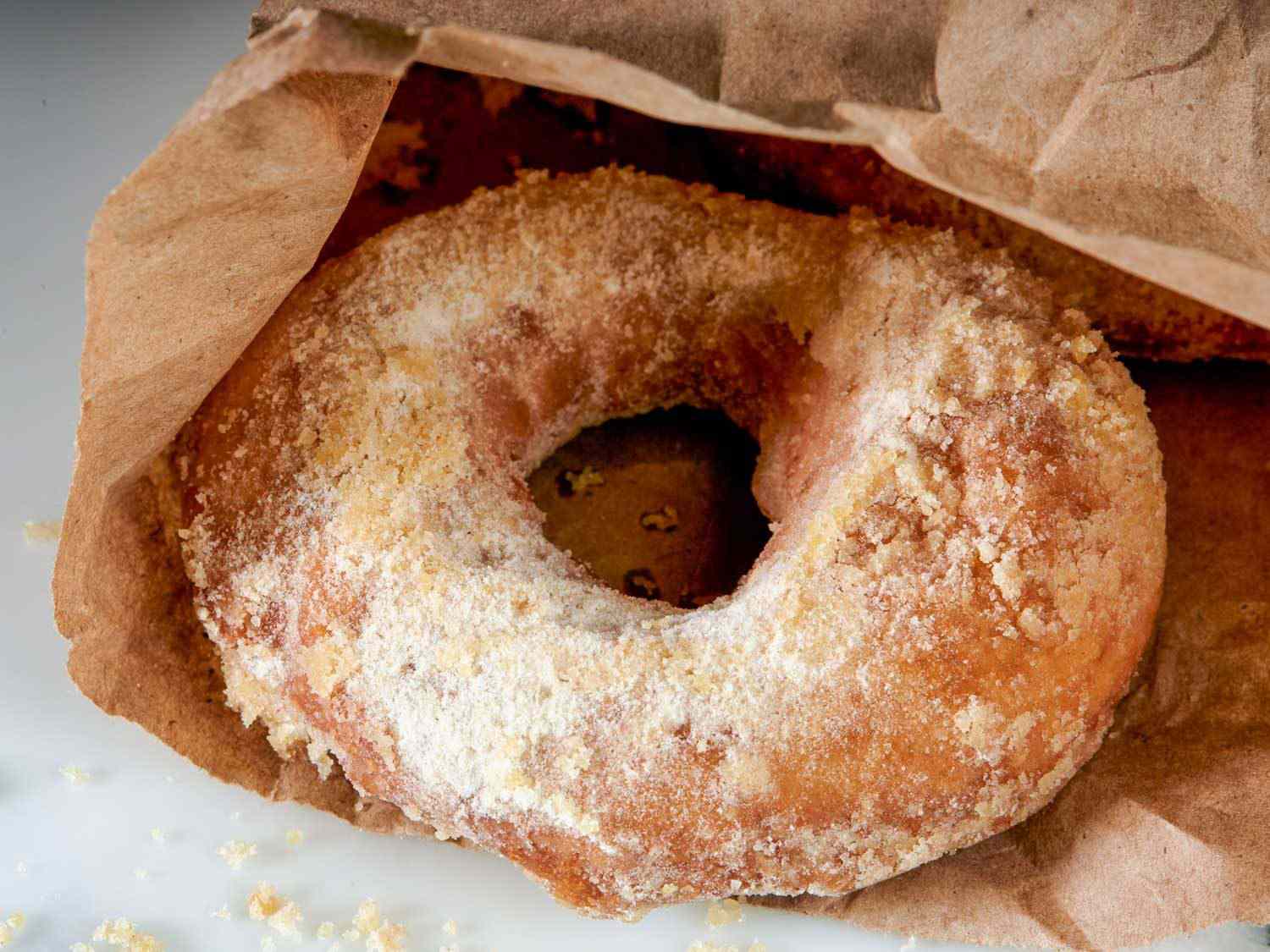 apple cider doughnuts in a brown paper bag