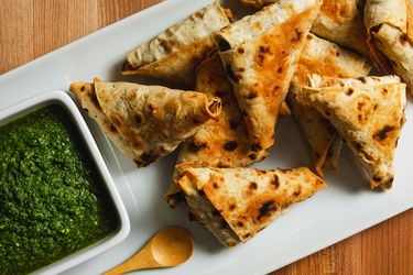 Lavash triangles on a serving platter with dipping sauce.