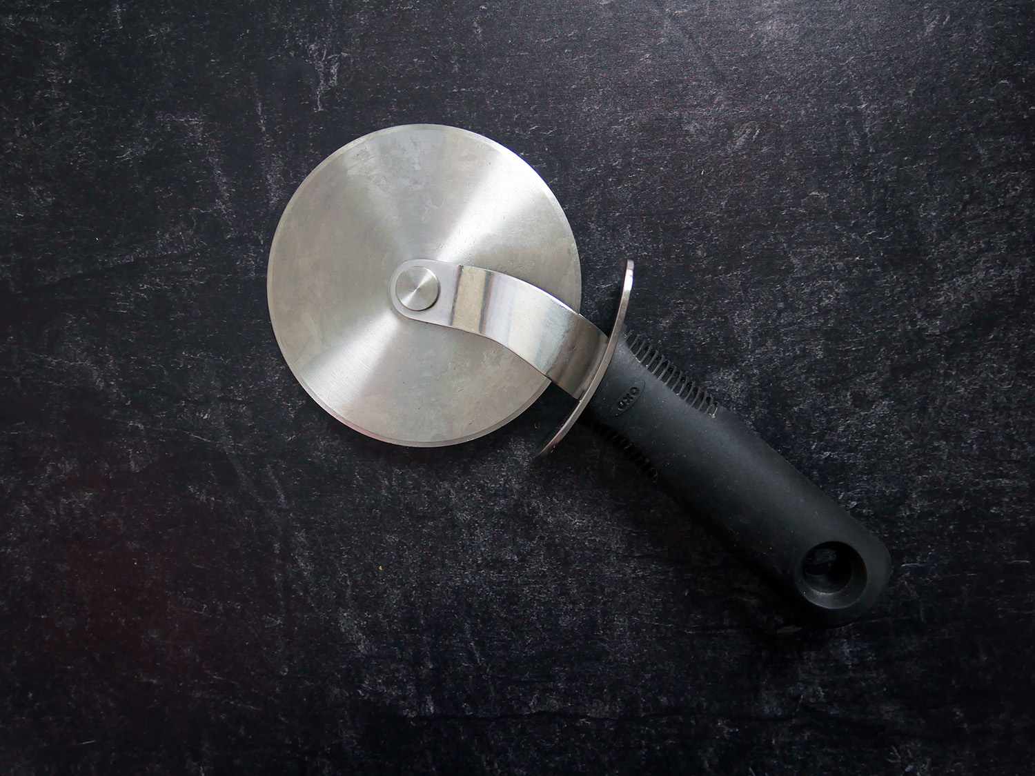 OXO pizza cutter on black backdrop