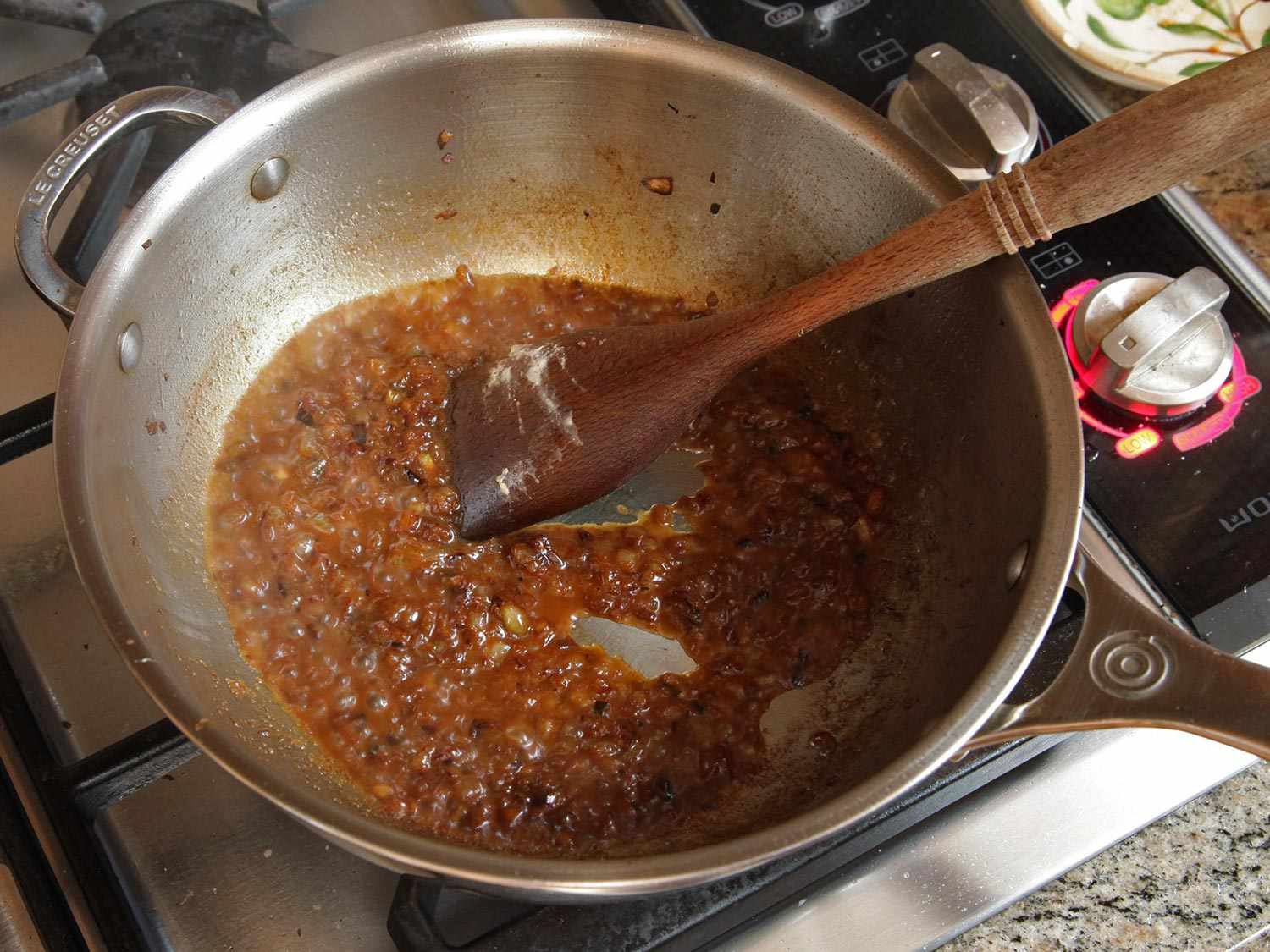 孜然和芥菜籽洋葱在大炖锅里焦糖化。gydF4y2Ba
