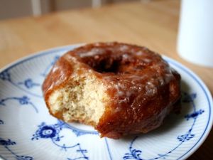 A homemade buttermilk cake doughnut on a blue and white plate