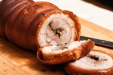 All Belly Porchetta sliced on a cutting board