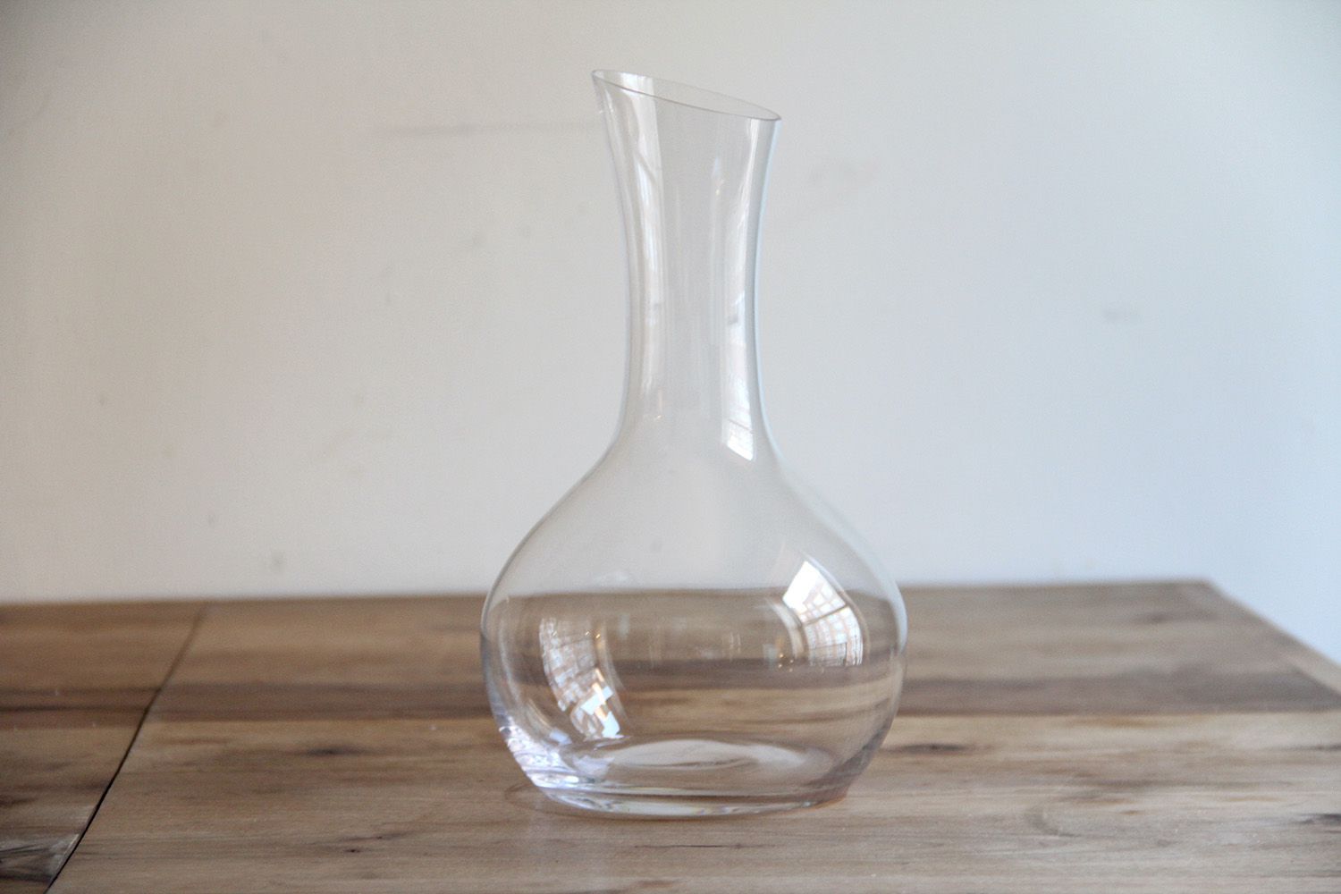 A wine decanter on a wodoen surface