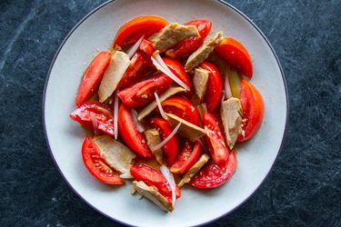 Overhead of a Spanish-style ripe tomato and olive-oil packed tuna salad.