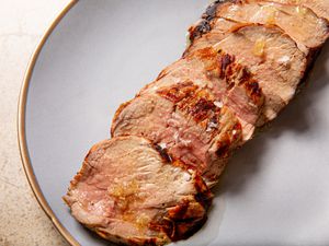 Slices of a grilled pork tenderloin on a plate