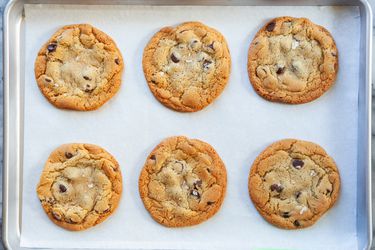 baked cookies on a piece of parchment paper on a sheet pan.