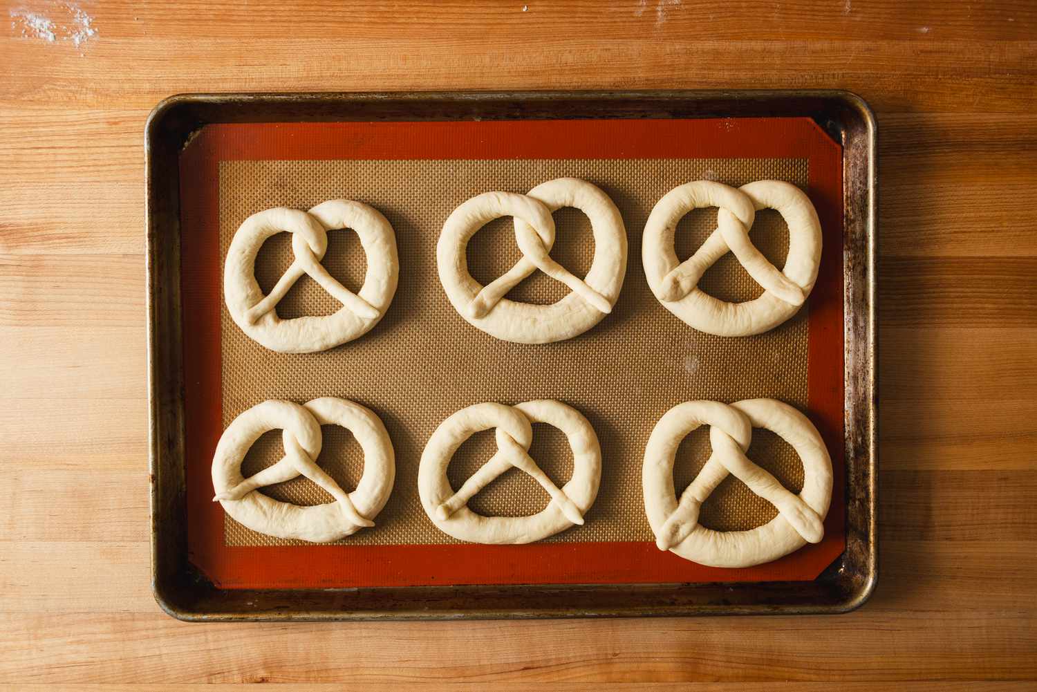 formed pretzels on baking sheet