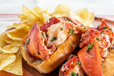 Two lobster rolls overflowing with lobster