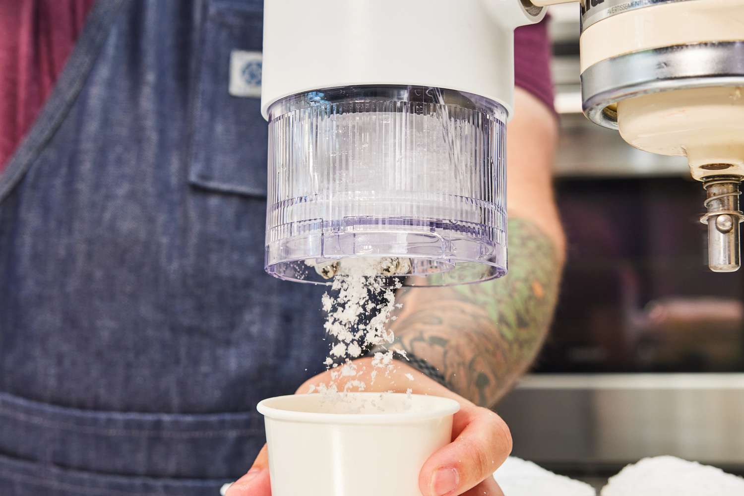 shaved ice coming out of an ice maker