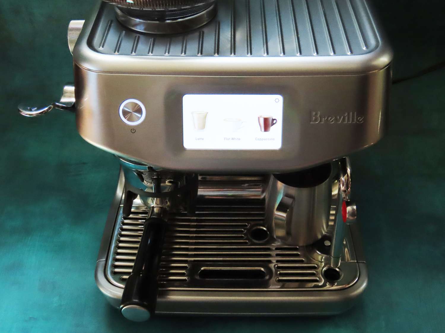 a Breville espresso machine with a touchscreen on a blue surface