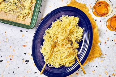 Overhead view of spaghetti squash on a blue plate