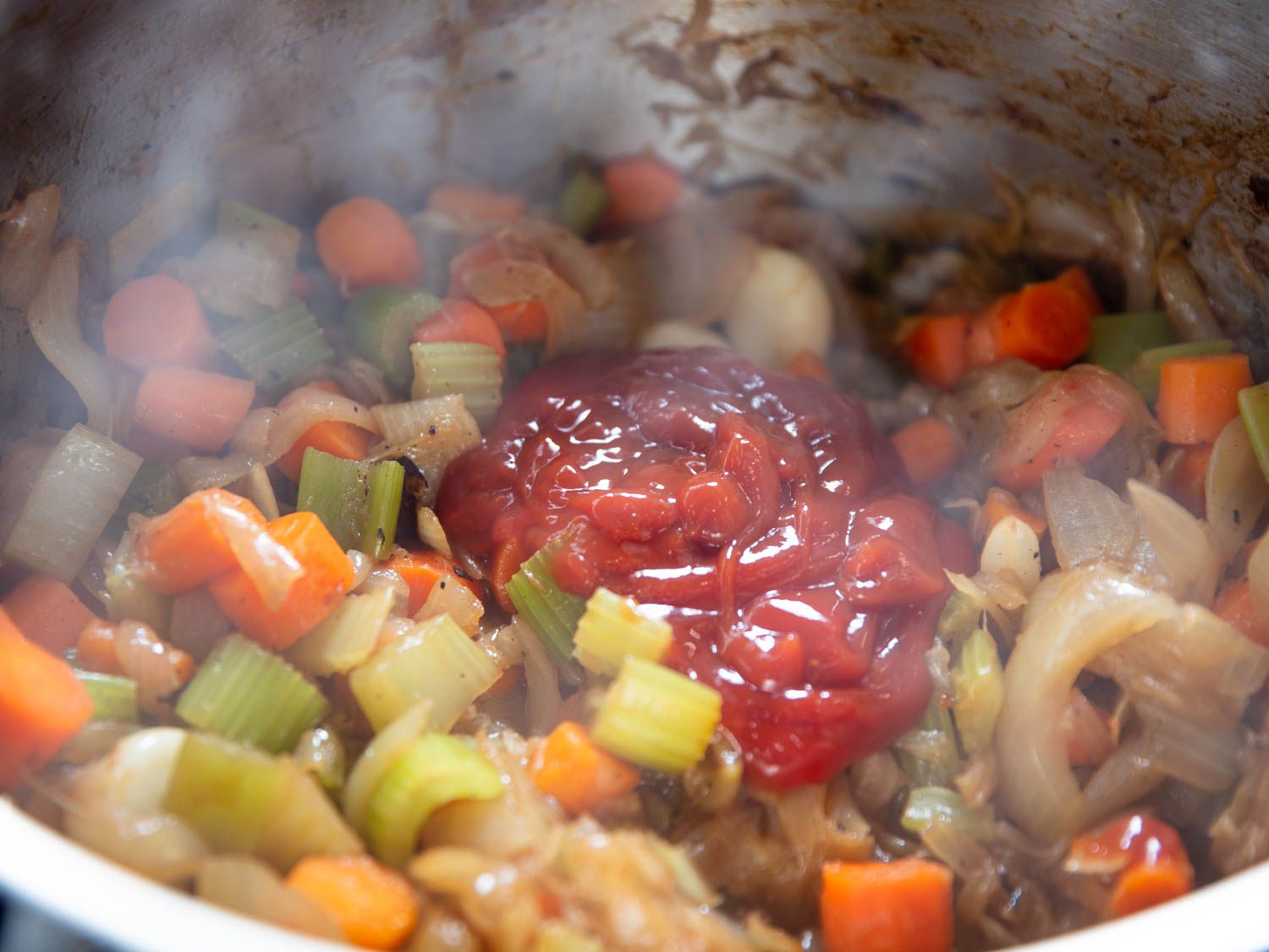 Ketchup is added to the softened aromatics in the pressure cooker