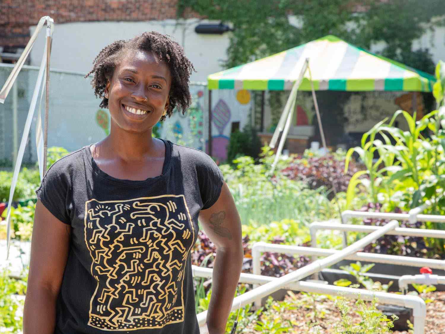 Yemi Amu standing in front of some of the planters at at Oko Farms