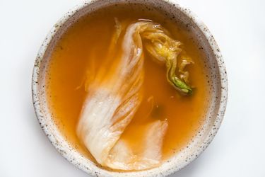 Kimchi in a bowl with broth.