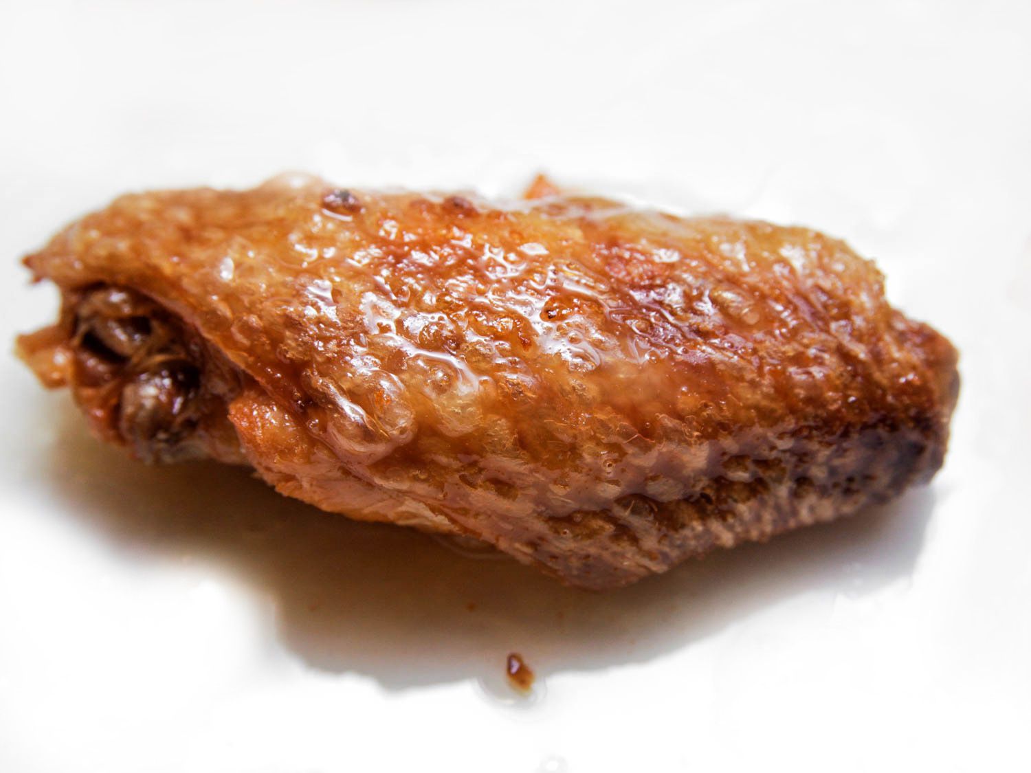 Twice-fried chicken wing flat with blistered, crackly browned skin