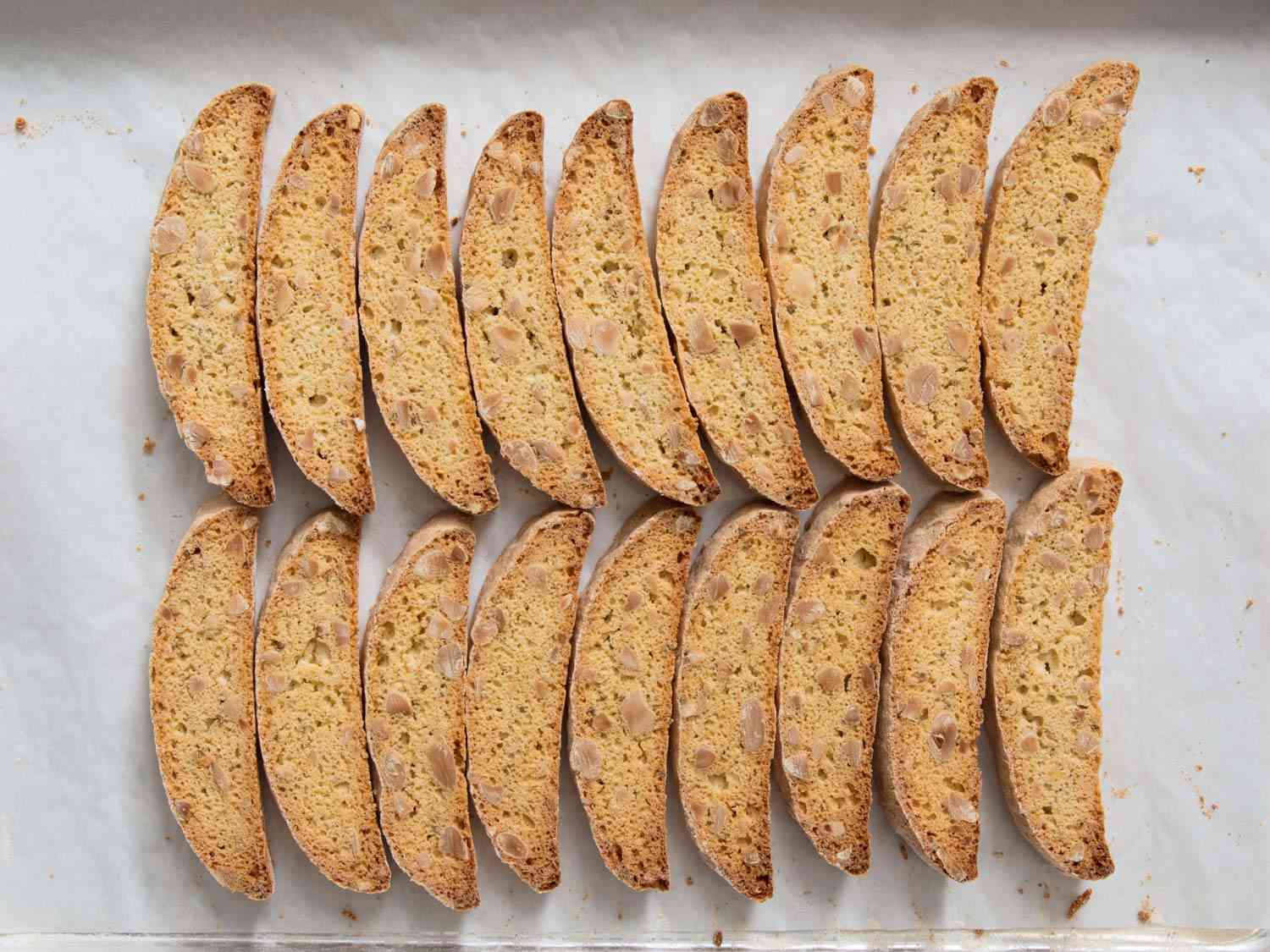 Slices of fully browned biscotti on a baking sheet.