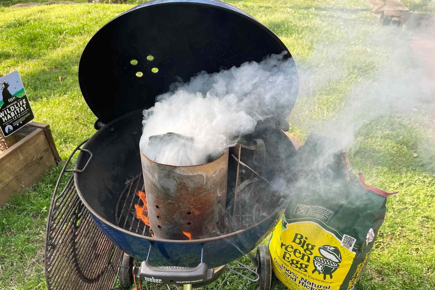 a charcoal grill with a chimney starter in it