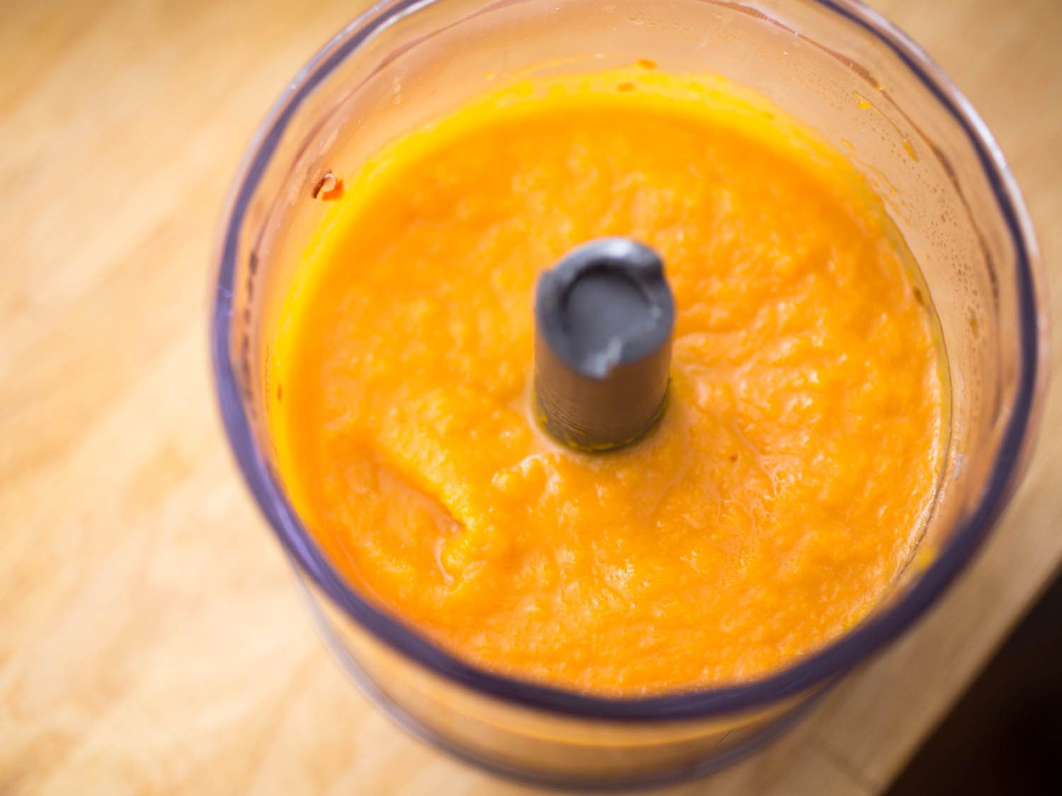 Overhead view of butternut squash purée in blender canister