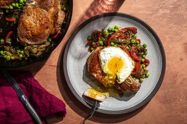 Overhead view of a plate of Costillas a la Riojana with an egg on top