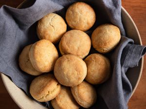 Batch of cream biscuits resting in an earthenware bowl