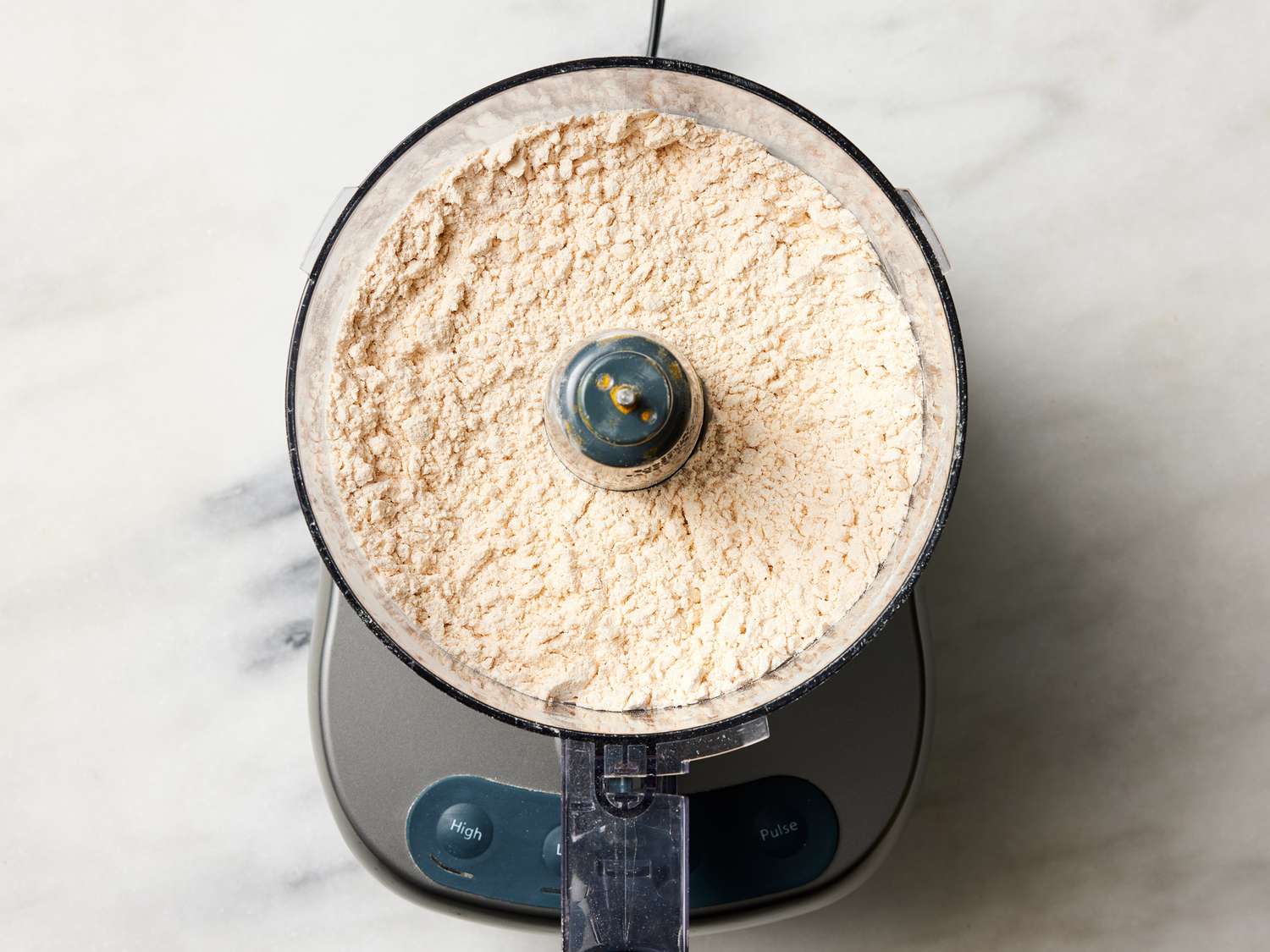 Overhead view of dough powder in food processor