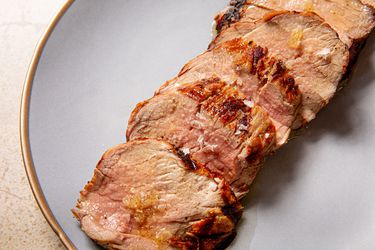 Slices of a grilled pork tenderloin on a plate