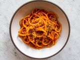 A white bowl with a dark gray rim holding a serving of Sicilian Pasta With Anchovies and Toasted Breadcrumbs, Pasta c'Anciuova e Muddica Atturrata