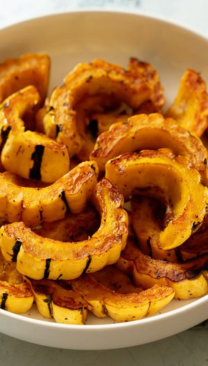 Roasted delicata squash slices in a serving bowl