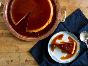 Overhead of a double-caramel flan with a slice on a plate