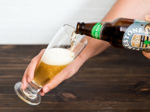 Pouring a beer in a glass.