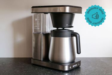 a side angle look at the oxo coffee maker sitting on a grey countertop