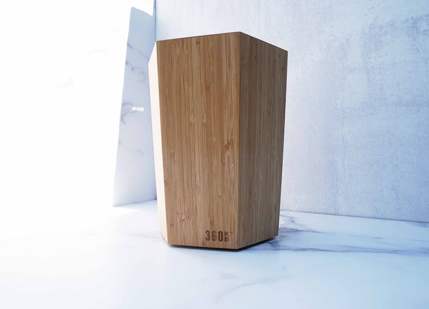 a wooden knife block on a marble surface