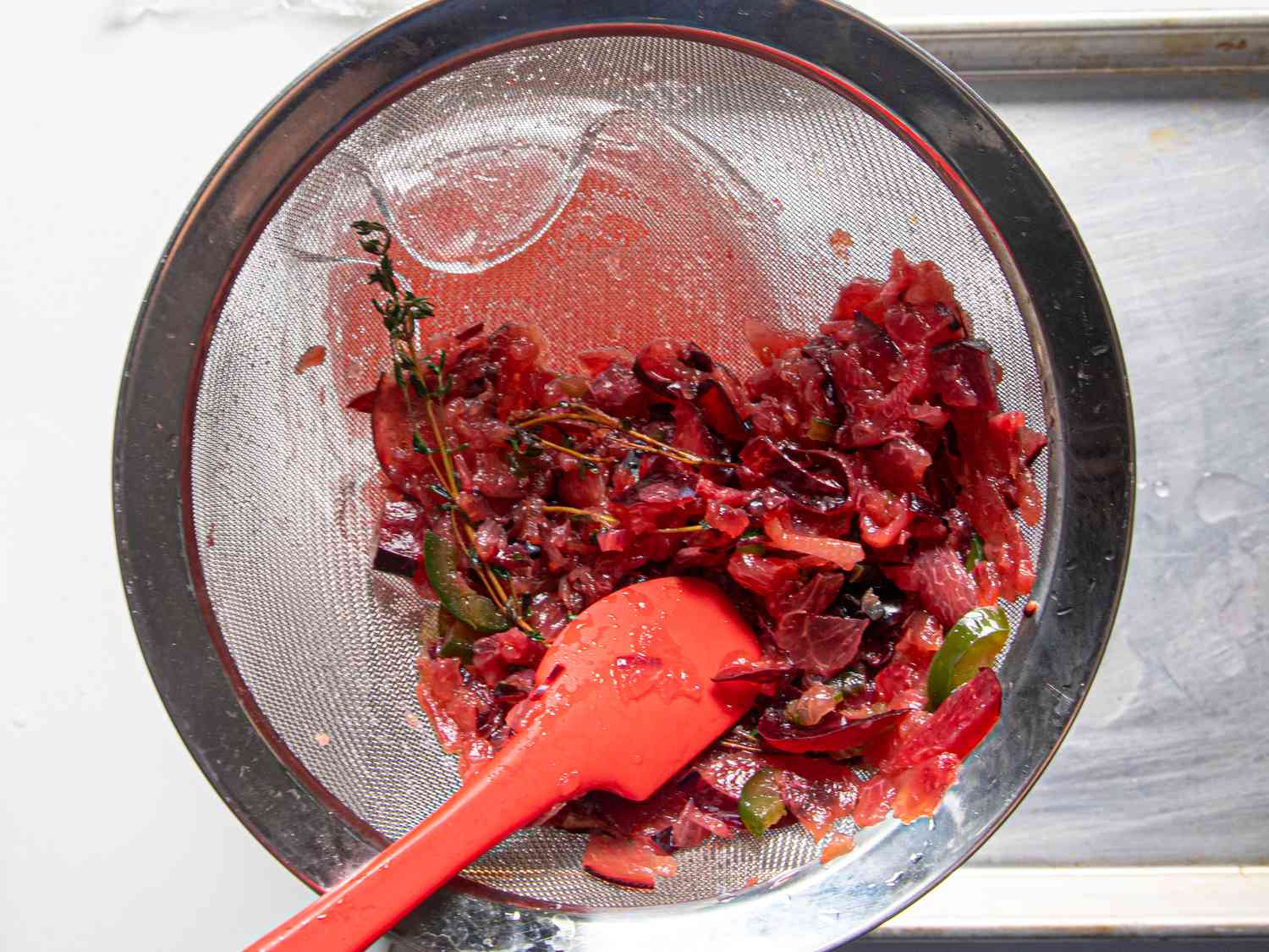 Straining fruit from water in fine mesh strainer