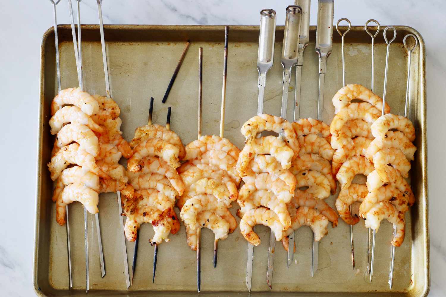 shrimp skewers on a sheet tray