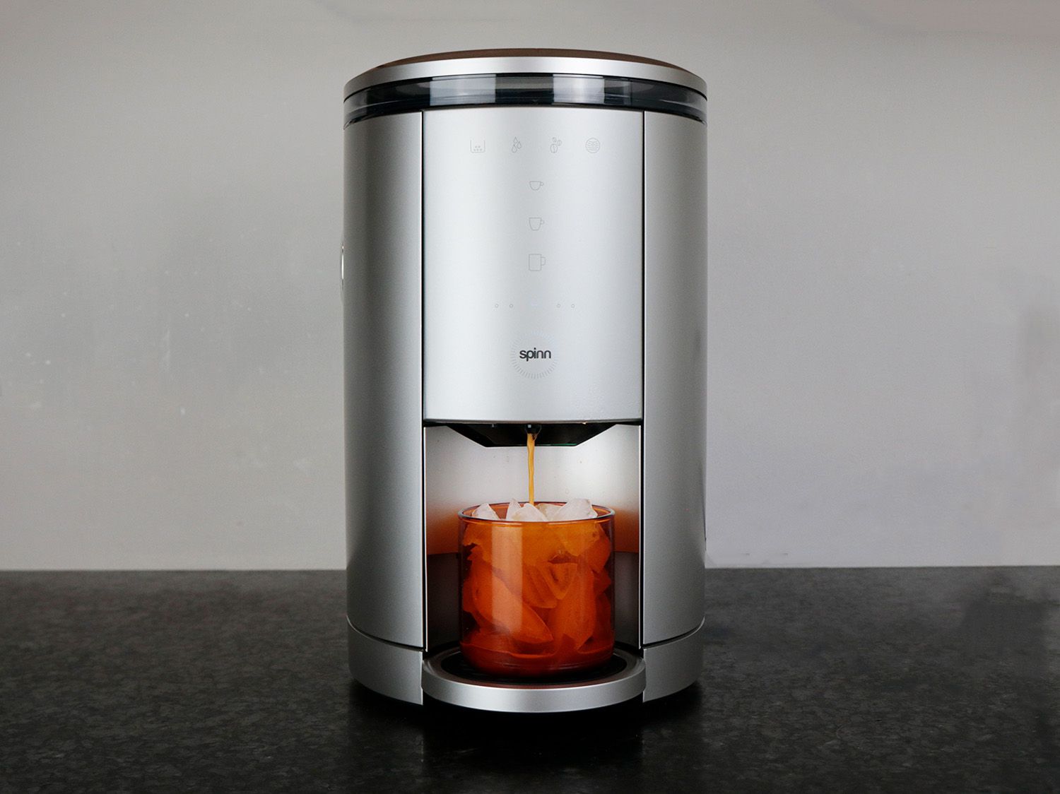 A spinn coffee maker brewing coffee over ice