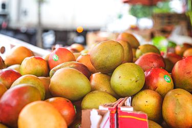 A stack of mangoes at a market