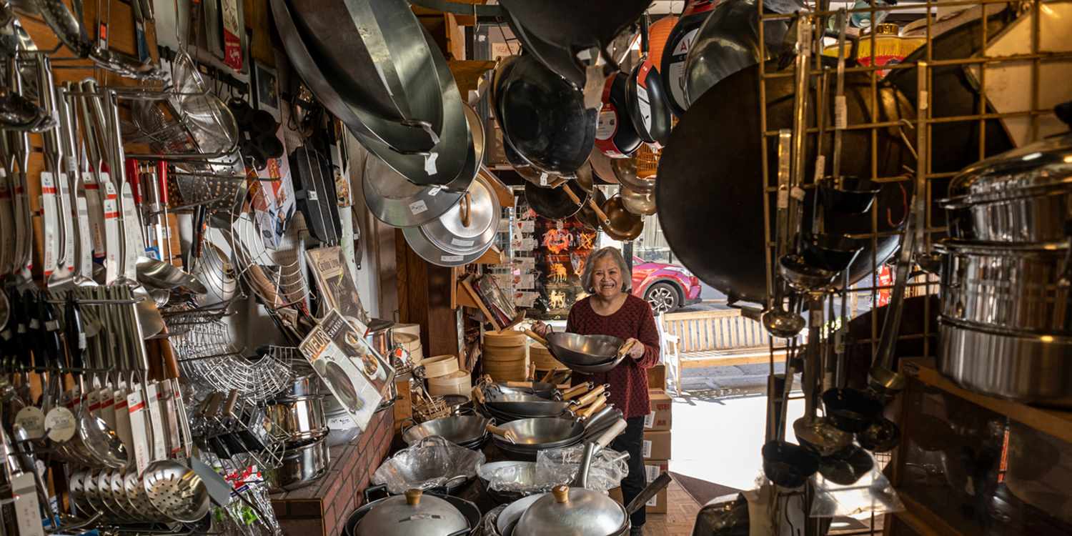 Tane Chan holding a wok in The Wok Shop