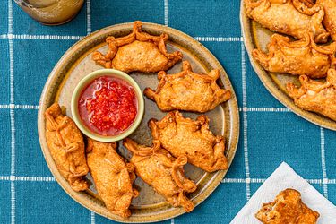 Overhead view of empanadas on a checkered blue background